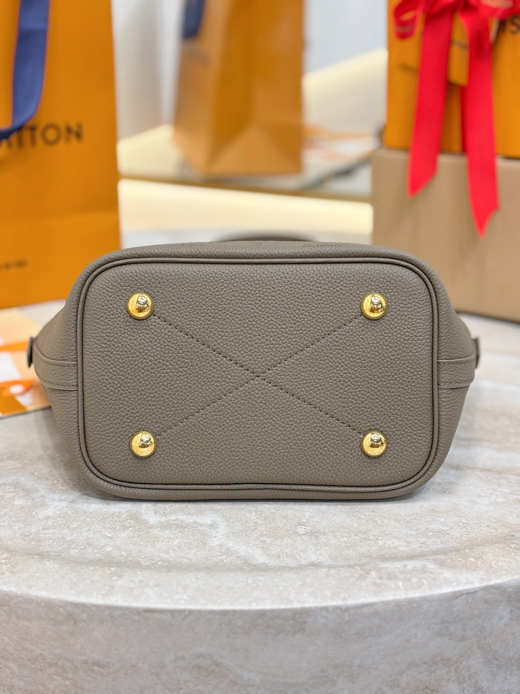Louis Vuitton gray vanity bag with quilted panel and gold-tone hardware