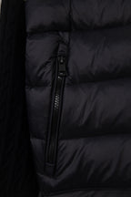 Moncler puffer jacket torso close-up, black quilted panels and zipper