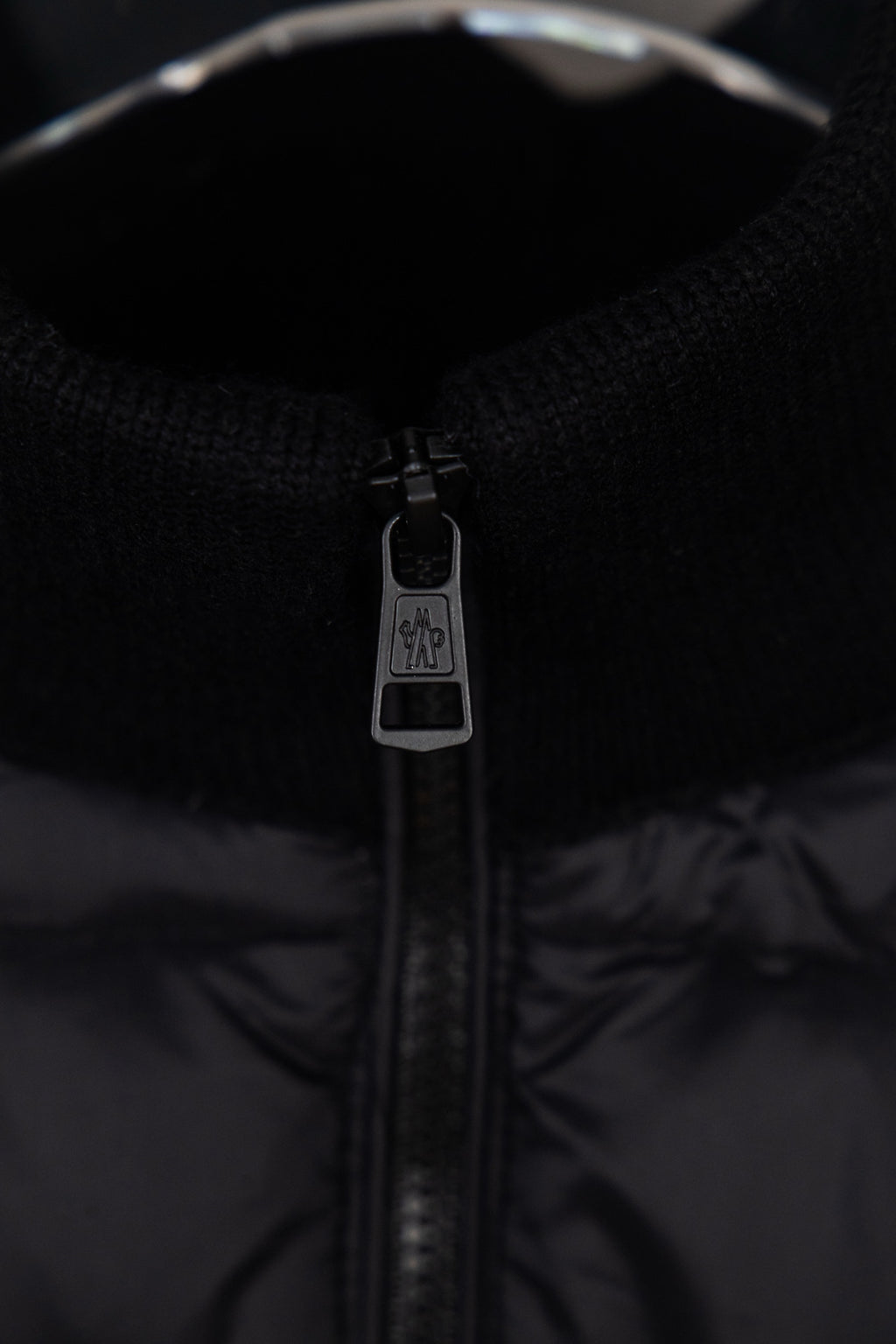 Moncler puffer jacket zip close-up with branded pull tab