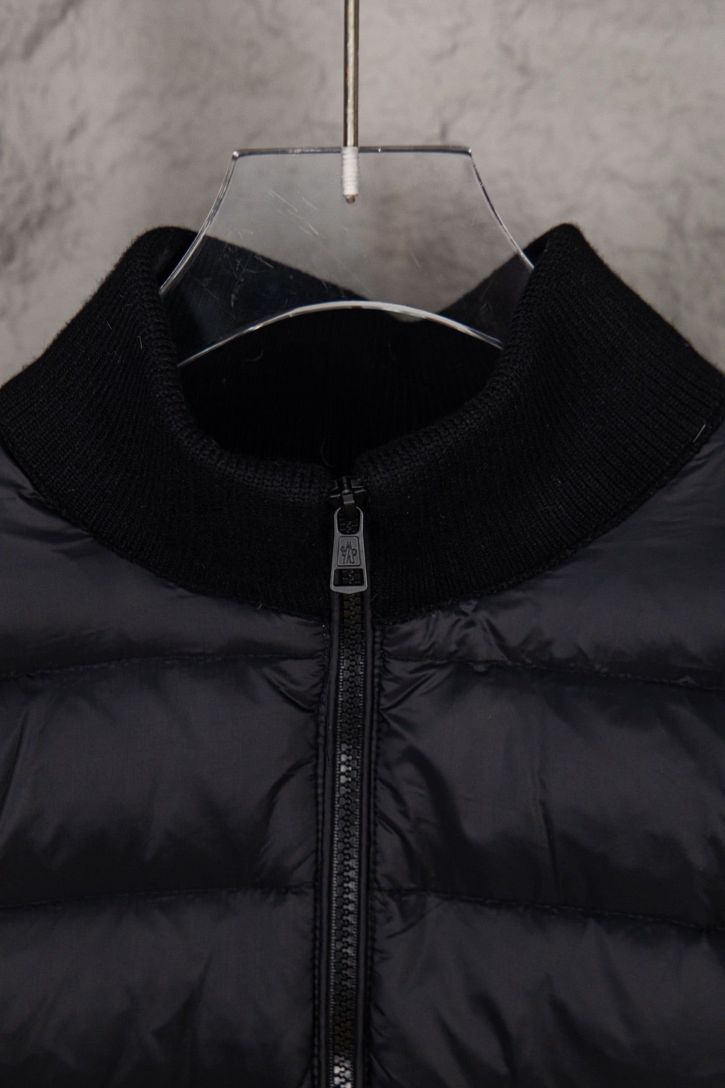 Moncler puffer jacket close-up, black stand collar and central zip