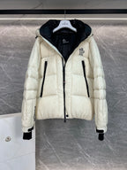 Cream long puffer jacket with hood, front zip, black-lined interior at collar