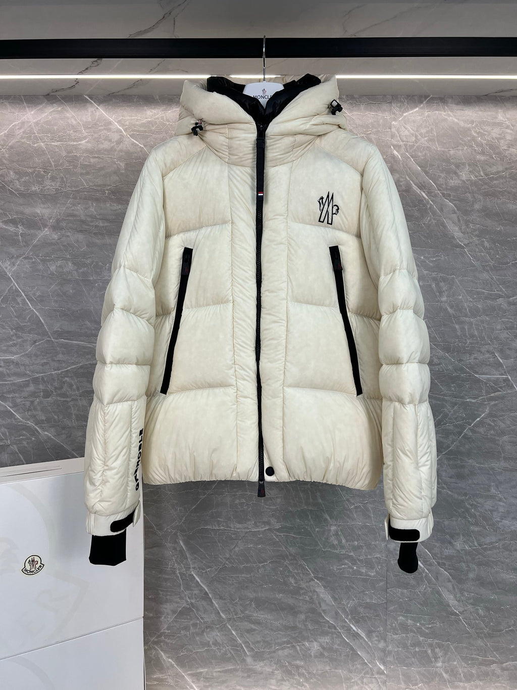 Cream long puffer jacket with hood, front zip, quilted panels, flap pocket detail