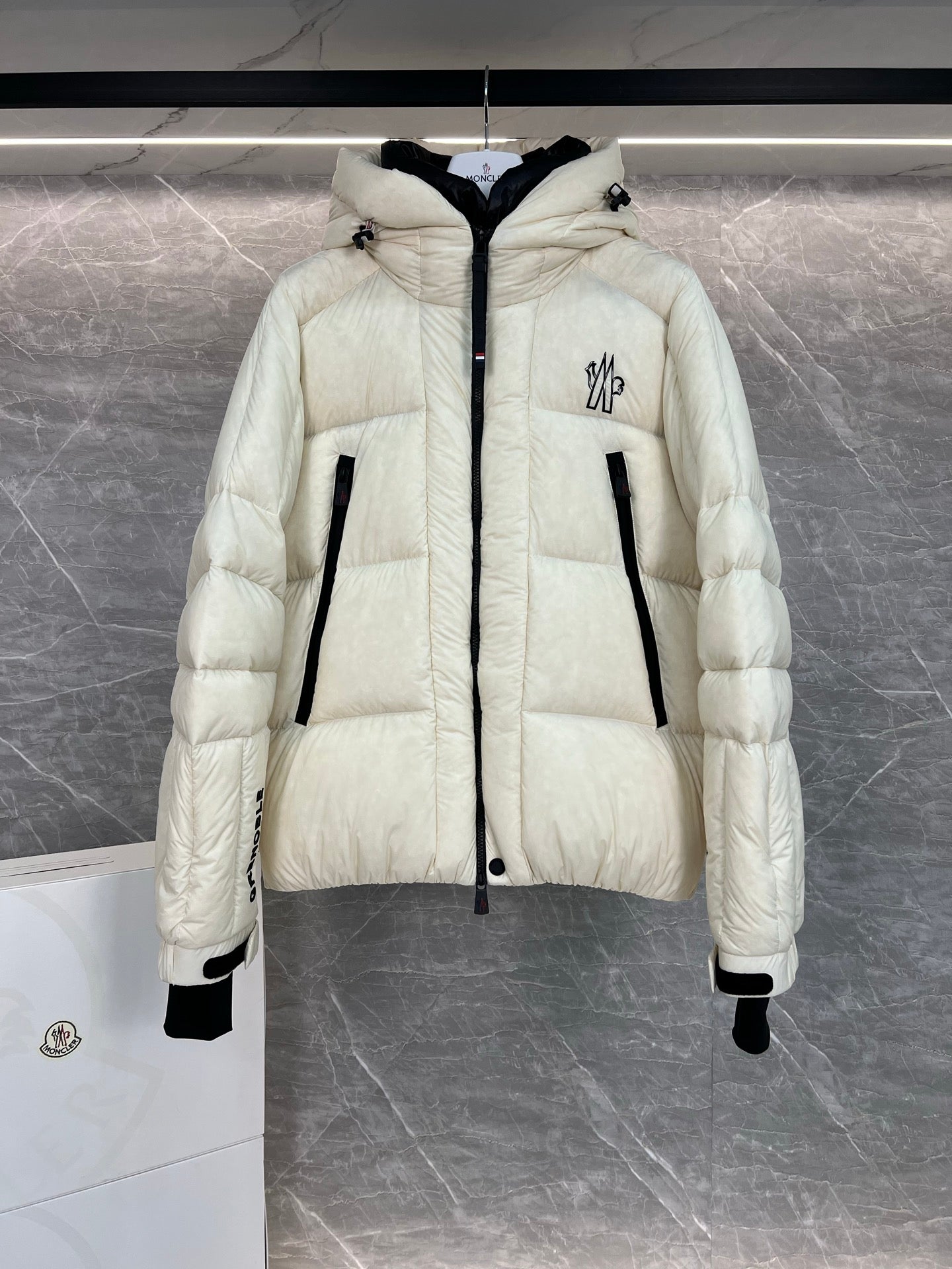 Cream long puffer jacket with hood, front zip, quilted panels, flap pocket detail