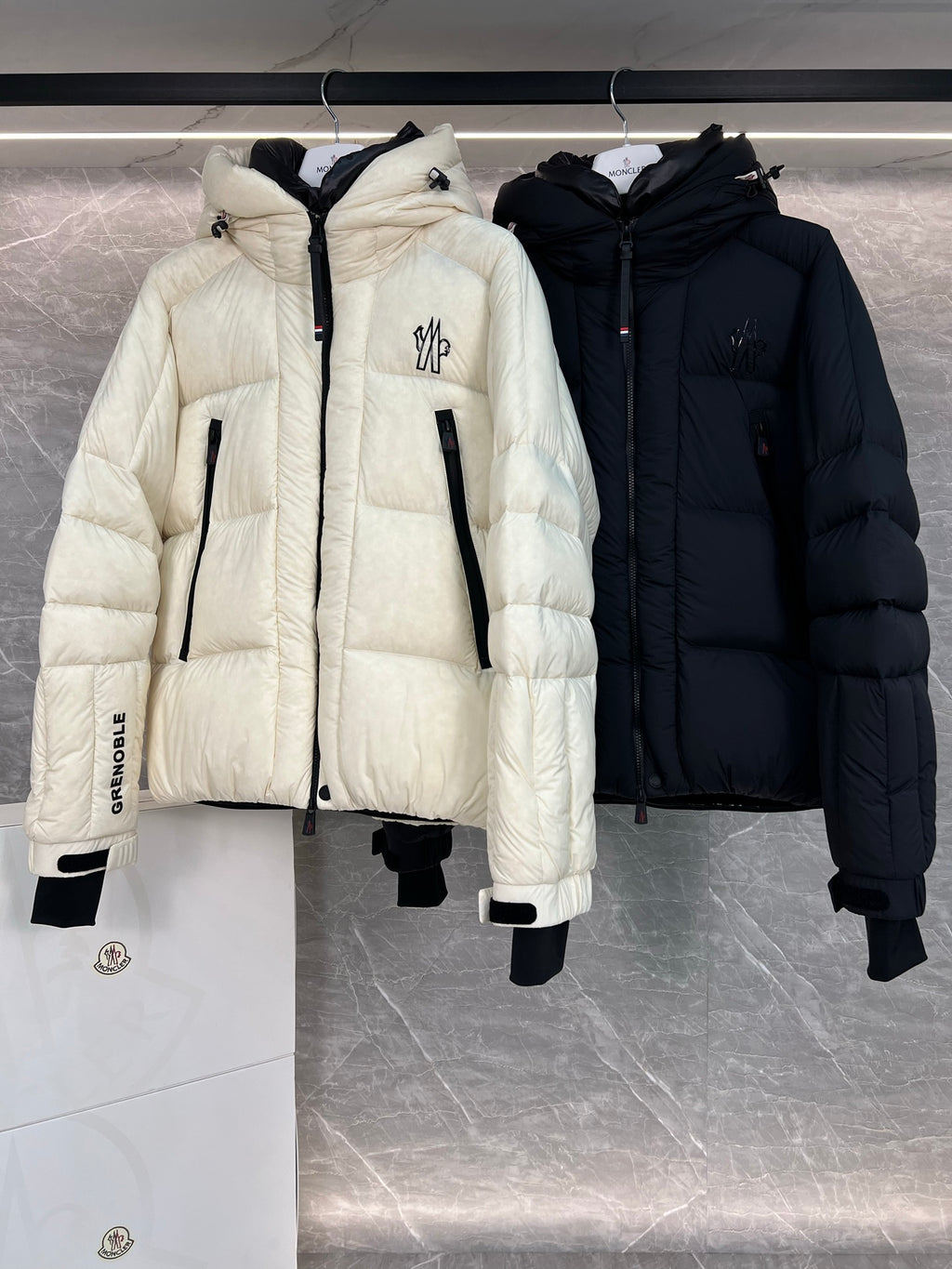 Cream long puffer jacket with hood, front zip, black inner accents, flap pockets