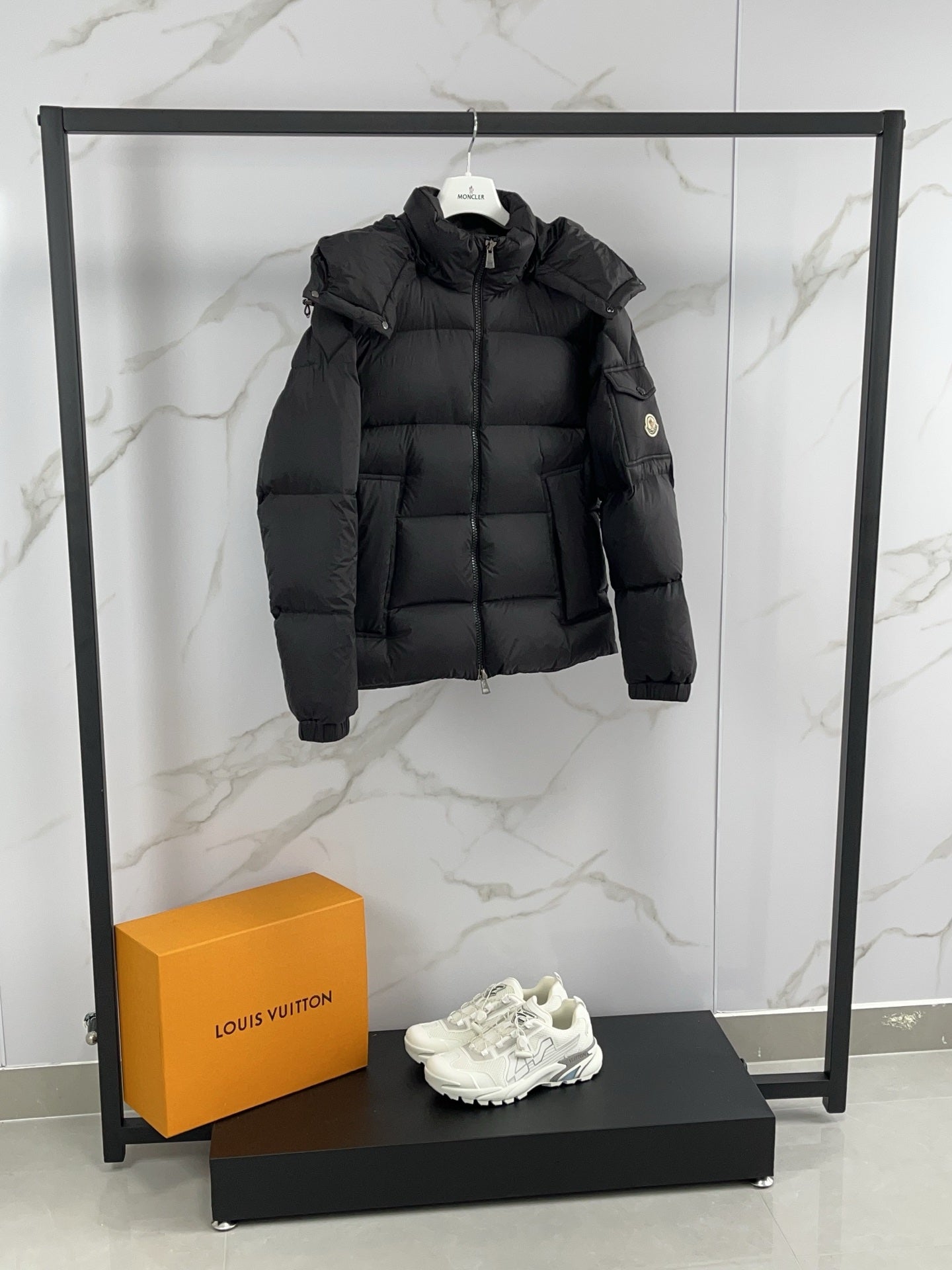 Moncler black hooded puffer jacket with full-zip front and elastic cuffs