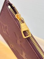 Louis Vuitton monogram bag zipper detail in dark plum with gold-tone zipper pull