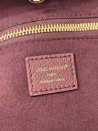 Louis Vuitton Paris made in France label on dark plum bag lining near zipper