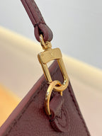 Louis Vuitton bag strap attachment with gold carabiner clasp, dark plum leather