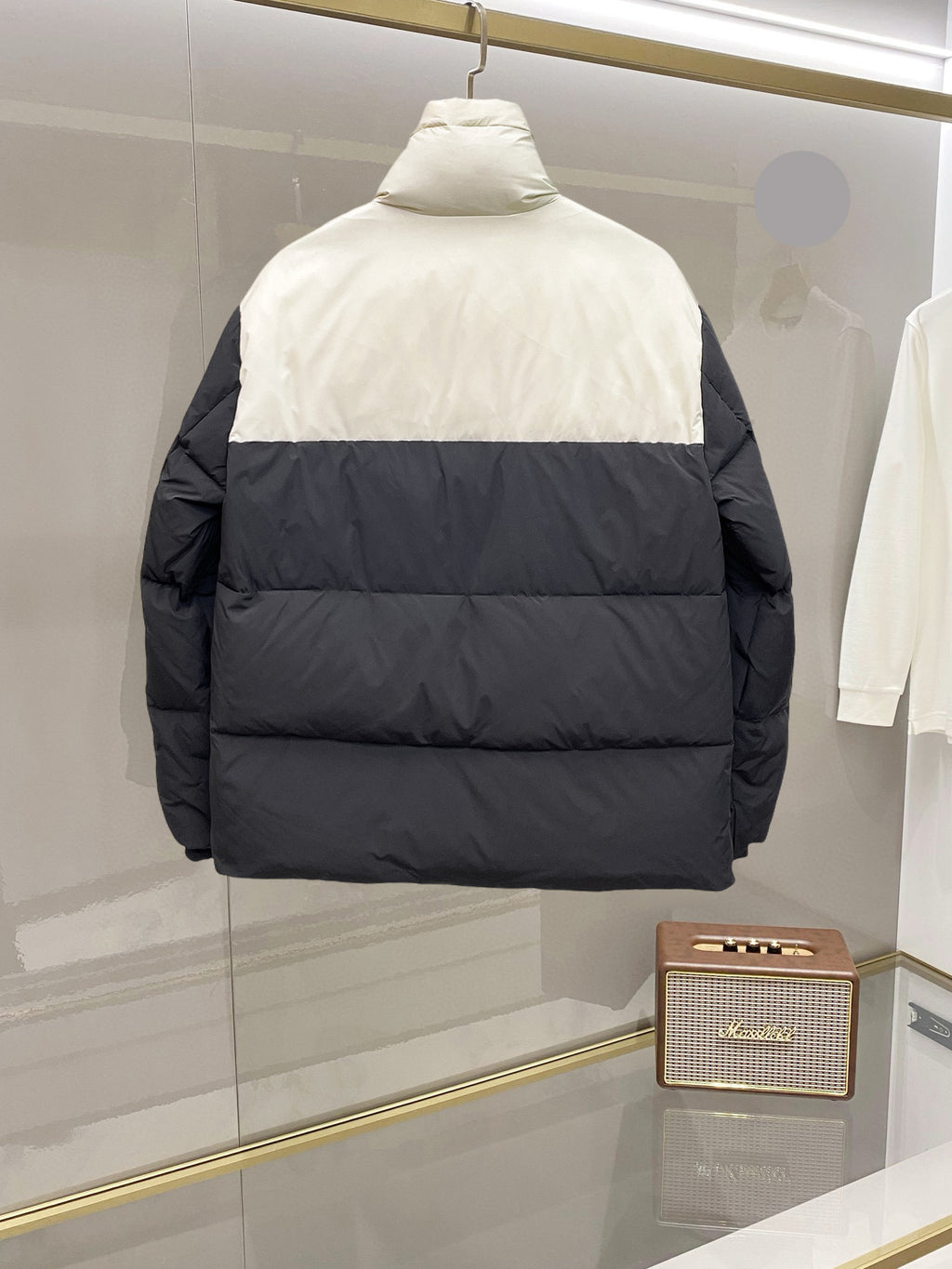 Two-tone puffer jacket with hood, back view, white upper and dark lower