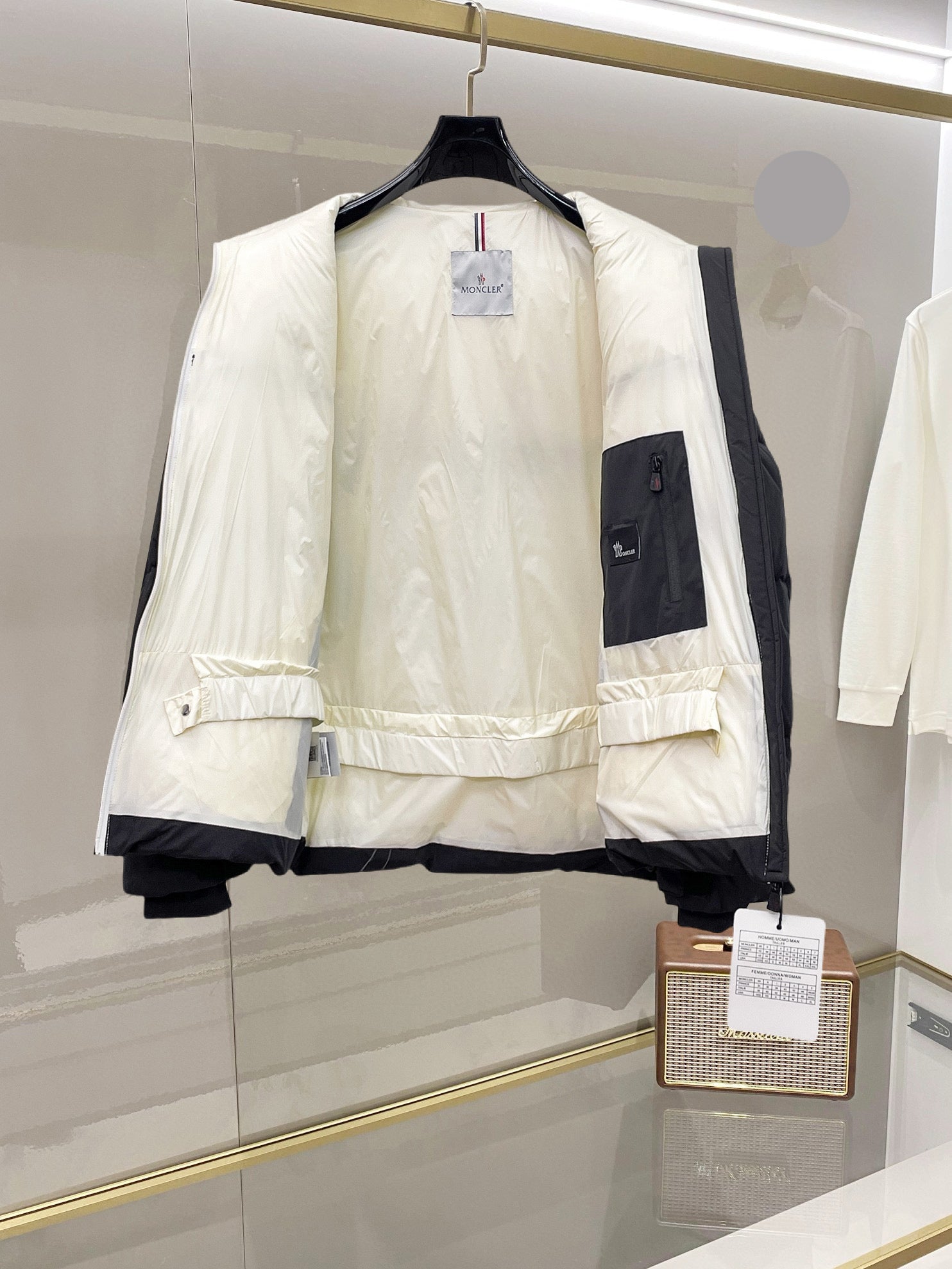 Open puffer jacket with hooded lining and elastic cuffs, white and dark