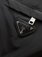 Black puffer jacket with Prada logo leather patch and metal rivets