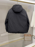 Back view of long black hooded puffer jacket with curved shoulder seams