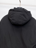 Long black puffer jacket hood with stitched seam and top edge detail