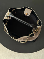 Two-tone Chanel handbag open view with gold-tone chain strap, top handle, and clasp