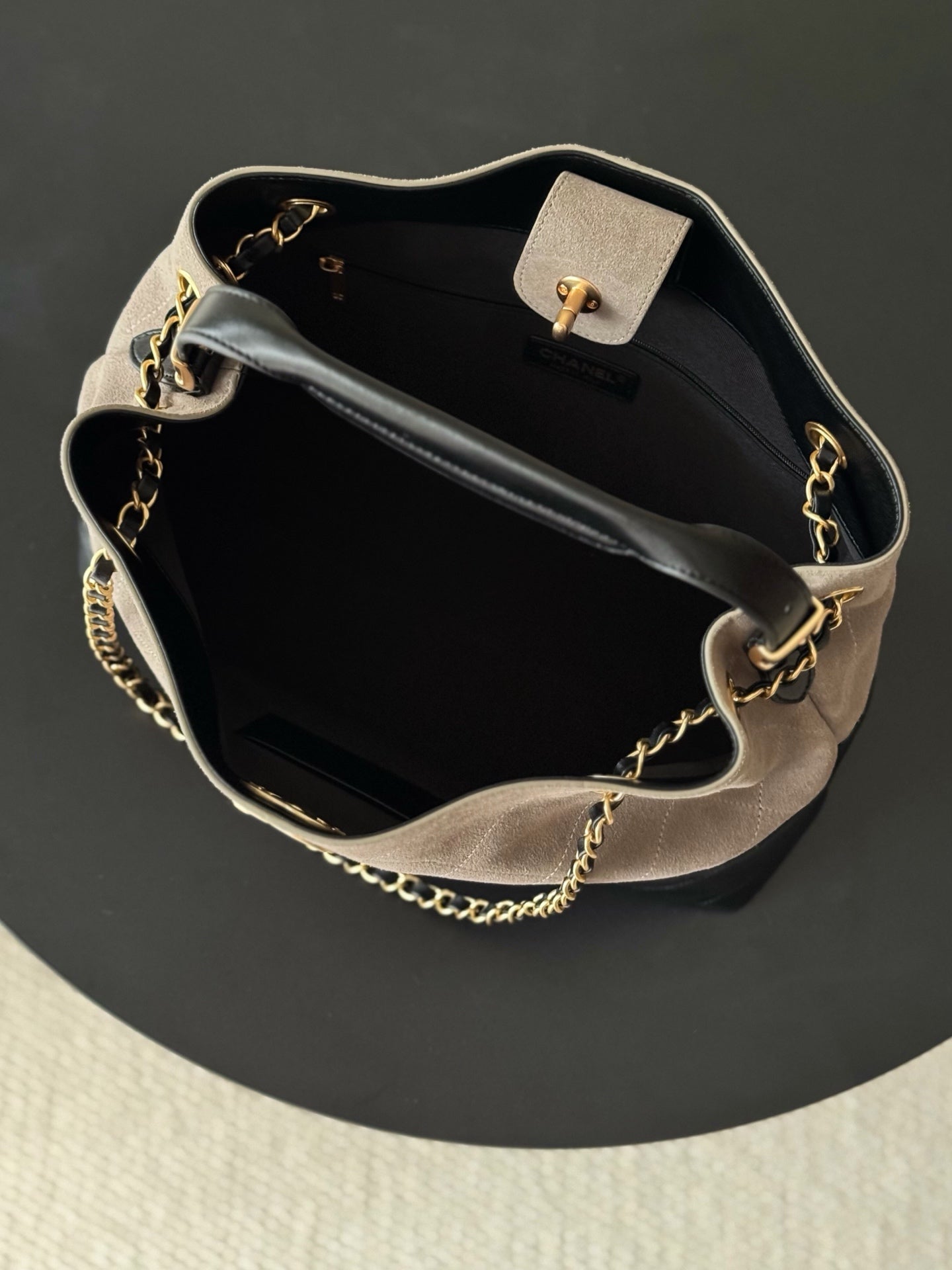 Two-tone Chanel handbag open view with gold-tone chain strap, top handle, and clasp