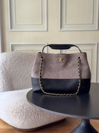 Two-tone Chanel handbag with gold-tone chain handles, quilted dark navy base, logo front