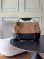Chanel two-tone hobo bag front view with gold chain strap and CC logo, tan and dark