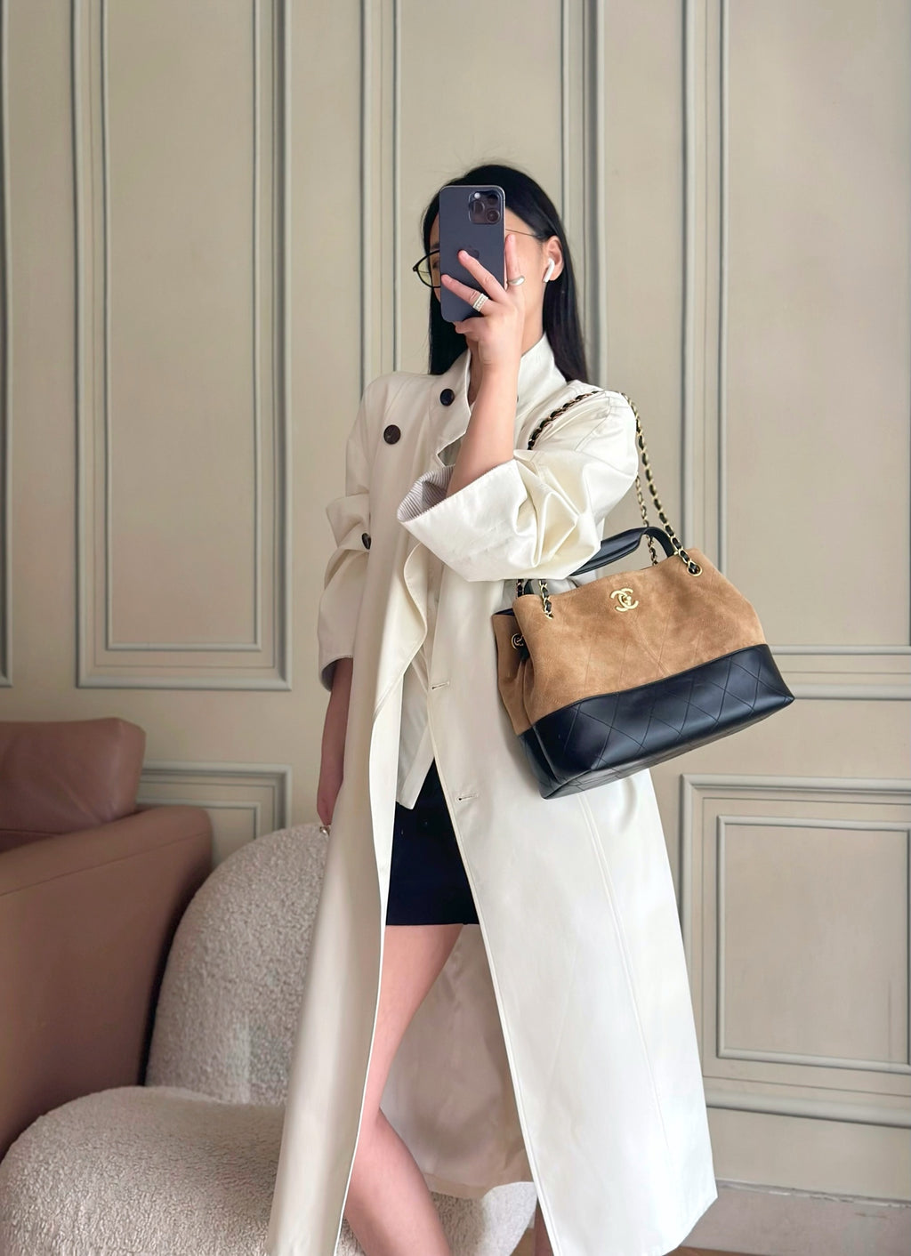 Chanel two-tone handbag worn crossbody with gold chain strap and CC logo, tan and dark