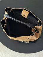 Chanel two-tone handbag open interior view with gold chain strap and snap pocket