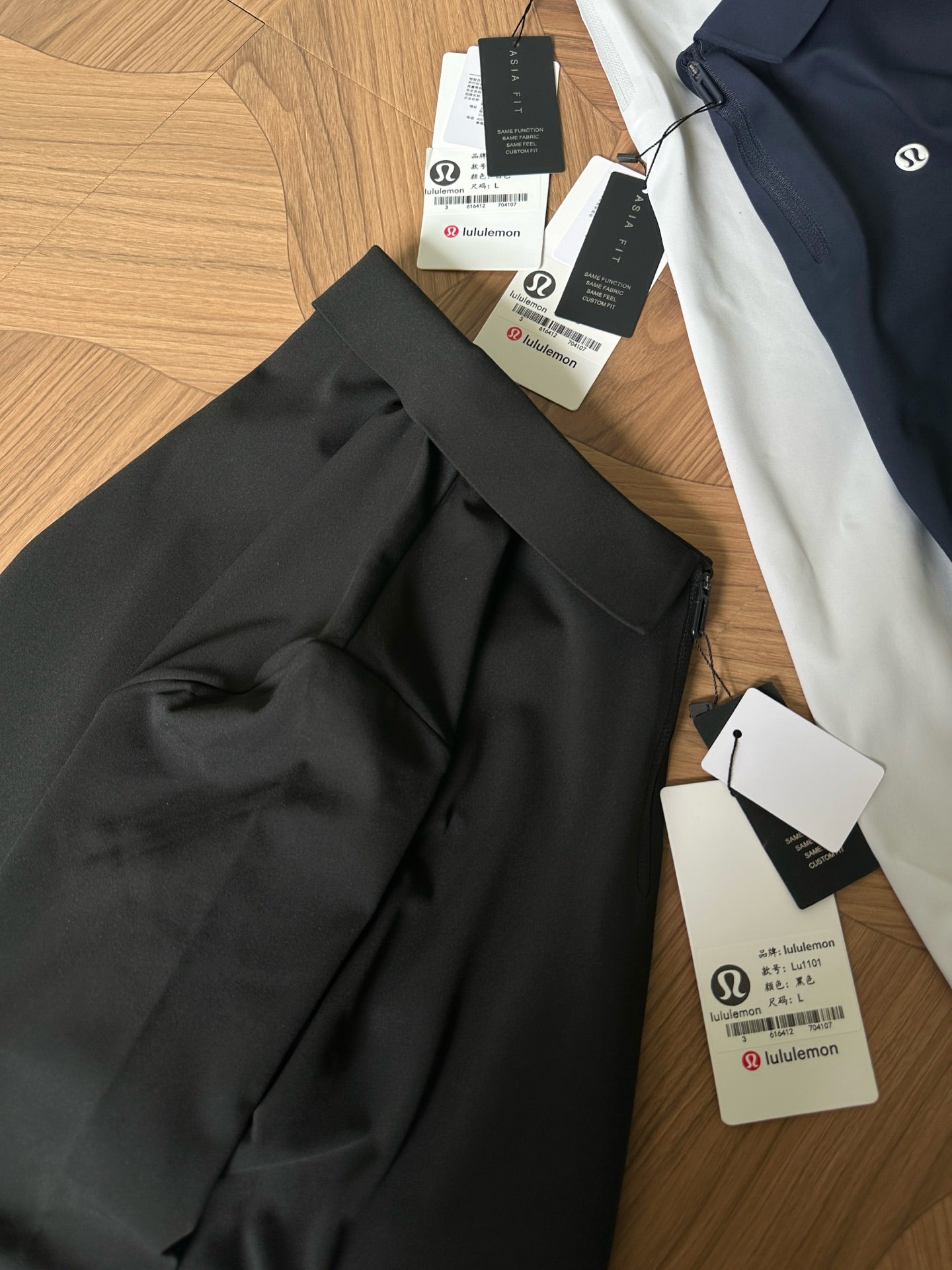 Black polo shirt with folded collar and hang tags