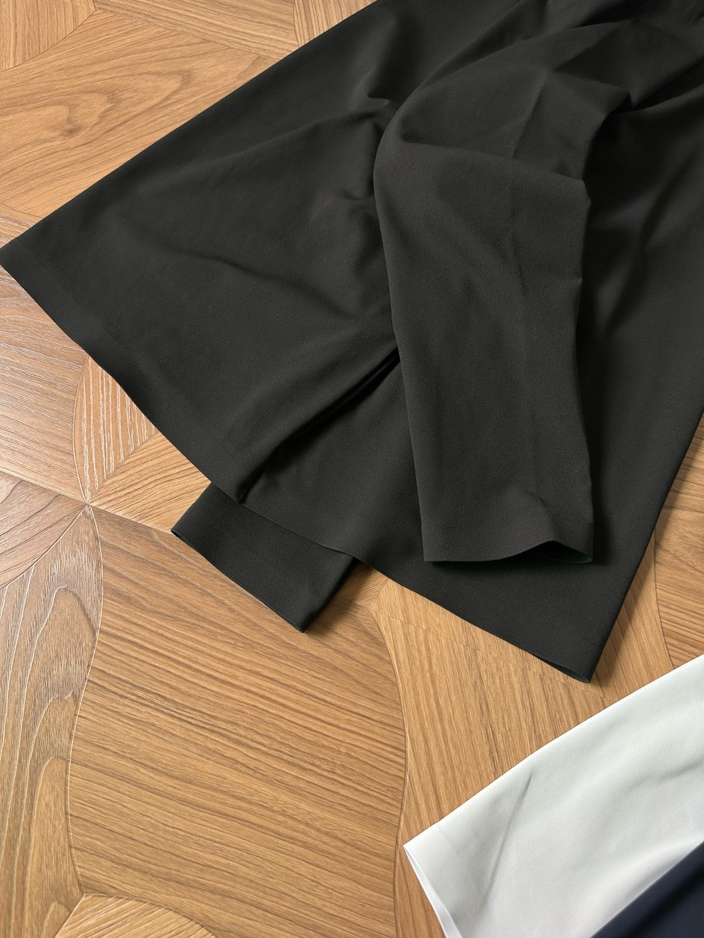 Black polo shirt folded with short sleeves and small chest logo