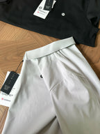 White polo shirt with stand collar, zip placket, and small chest logo