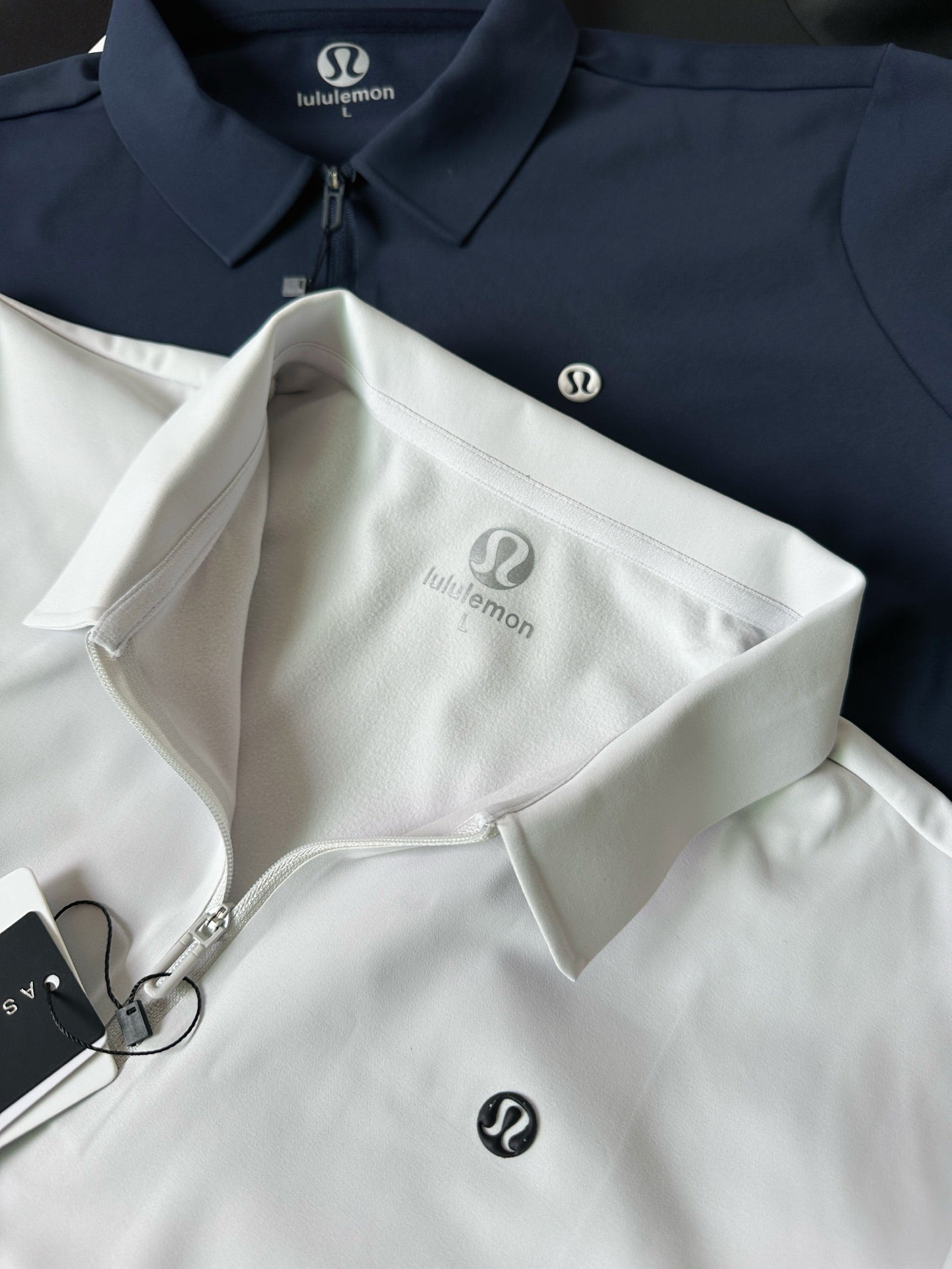 White polo shirt with stand collar, zip placket, and small chest logo