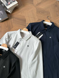 White polo shirt with button placket and small chest logo, short sleeves