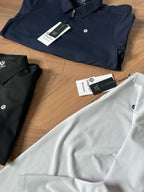 Set of polo shirts in navy, black, and white with hang tags