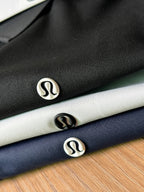 Closeup of polo shirts showing small chest logos on dark and light fabric