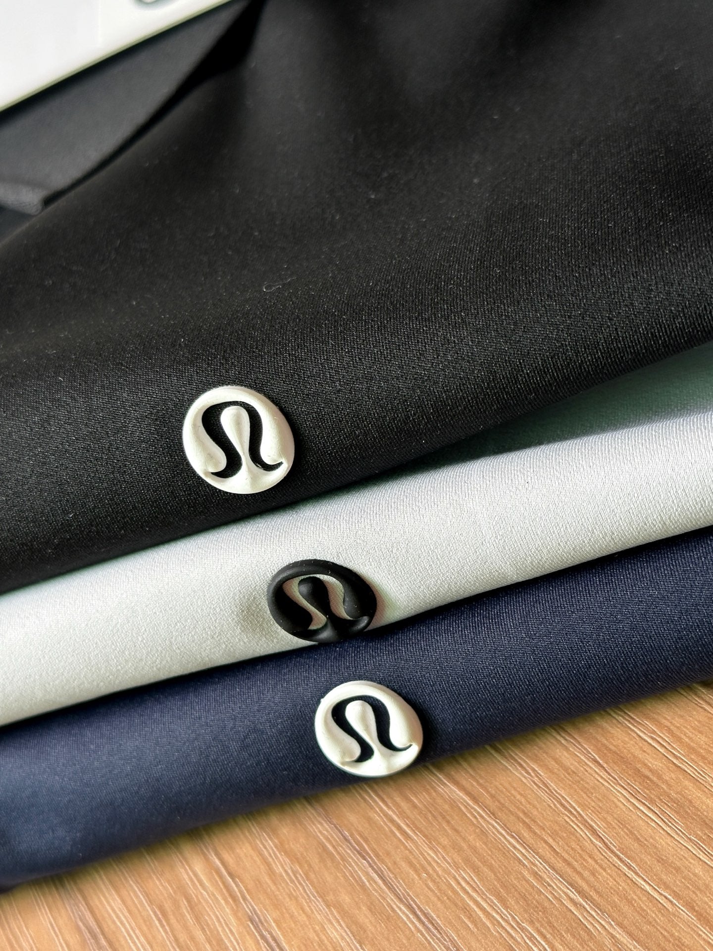 Closeup of polo shirts showing small chest logos on dark and light fabric