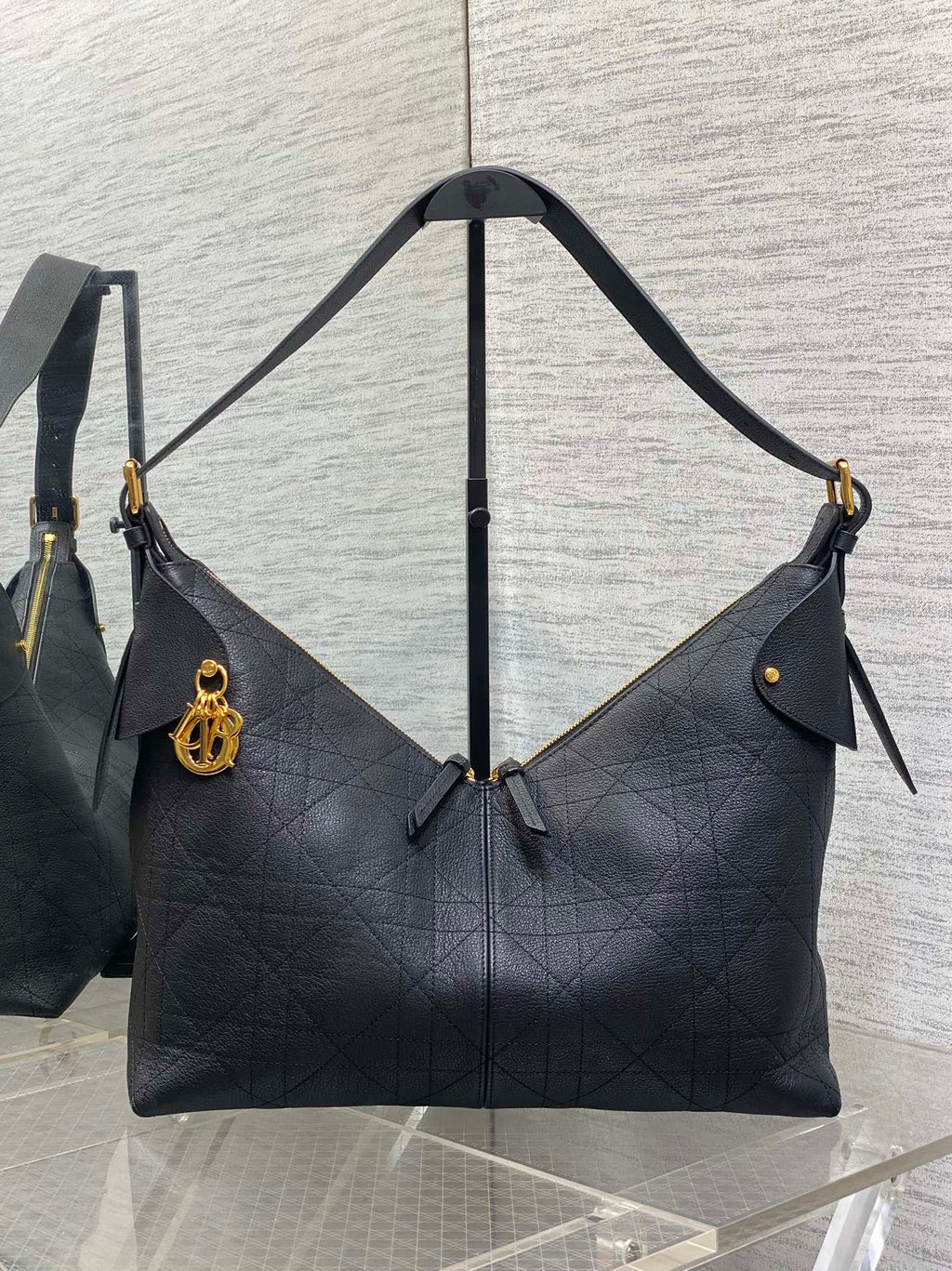 Dior quilted shoulder bag with top handle, gold-tone hardware, and side ties