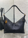Dior quilted shoulder bag with top handle, gold-tone hardware, and side ties