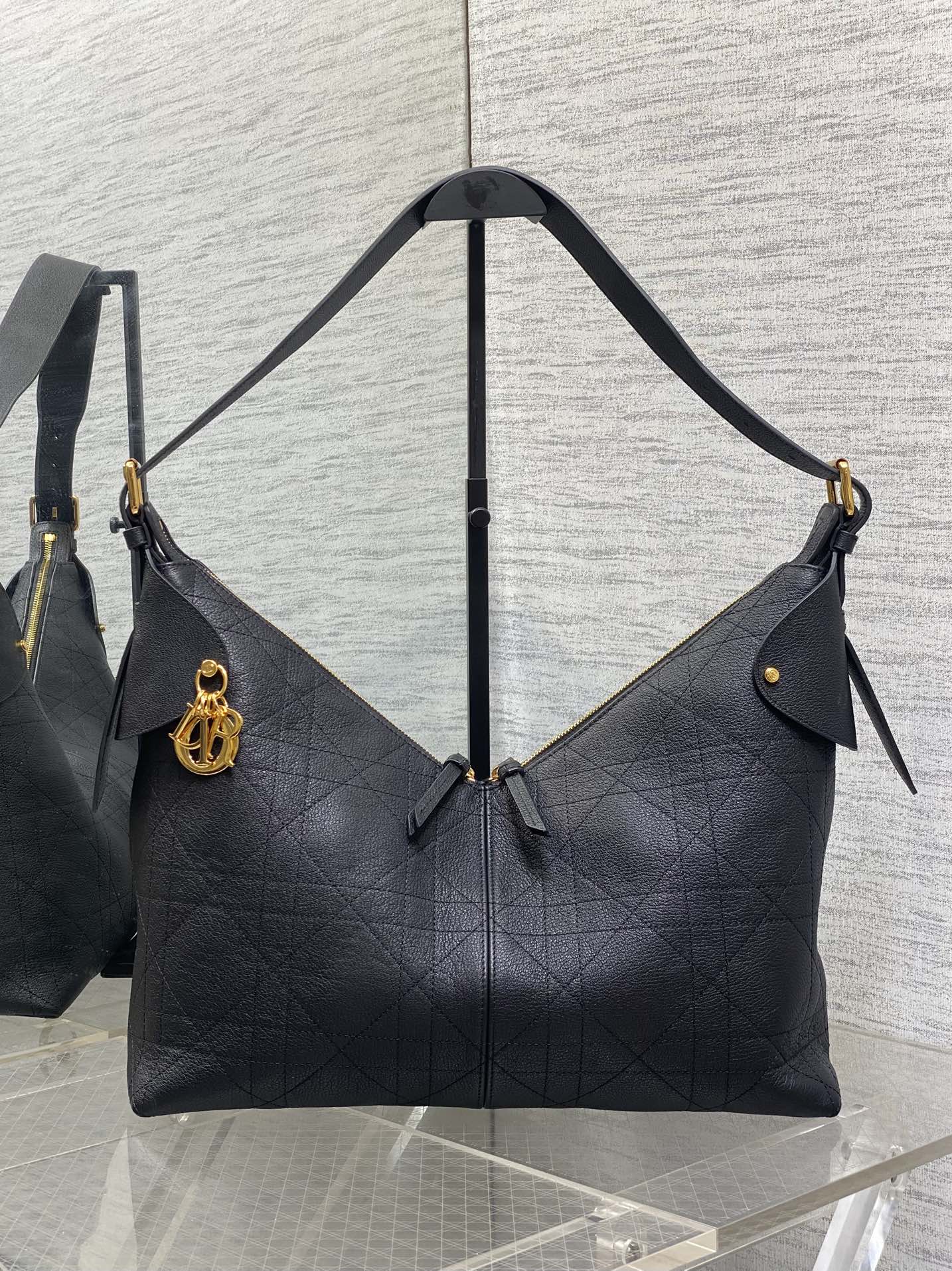 Dior quilted shoulder bag with top handle, gold-tone hardware, and side ties