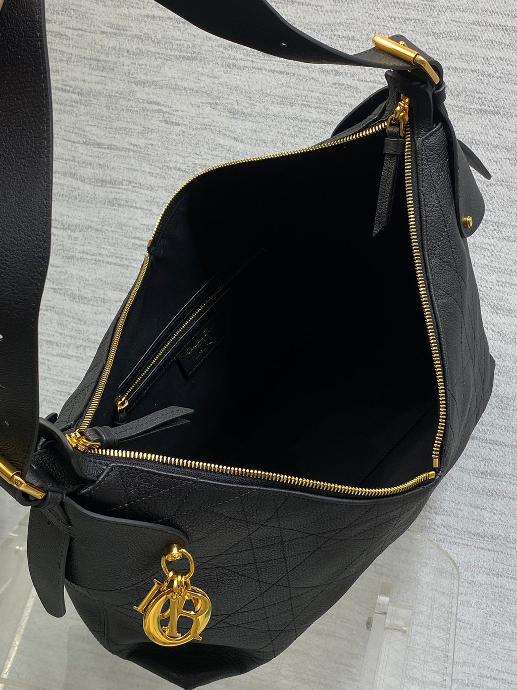 Dior quilted bag interior with gold-tone zipper and satin-lined compartment