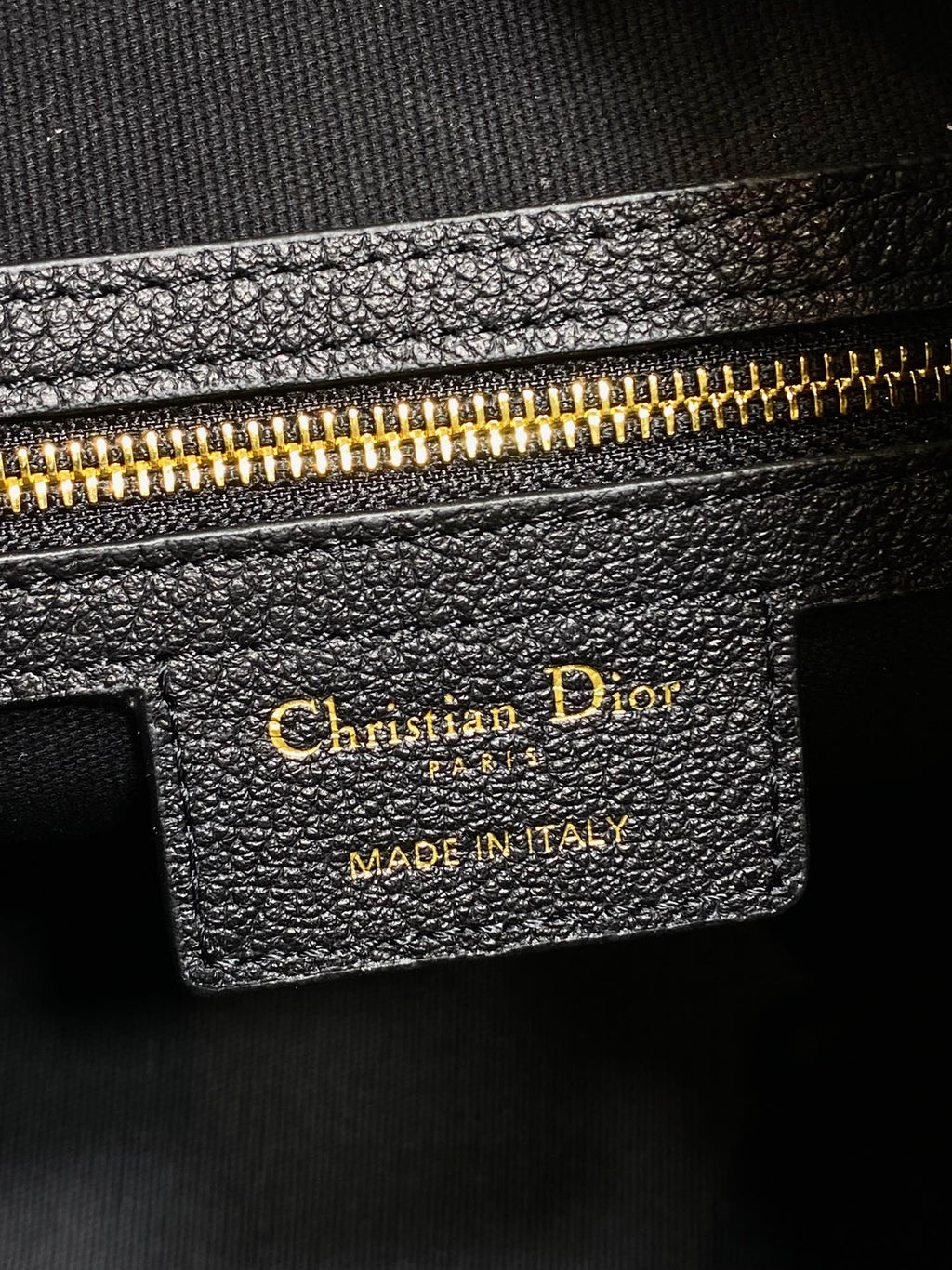 Dior leather bag label reading Christian Dior and Made in Italy