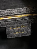 Dior leather bag label reading Christian Dior and Made in Italy
