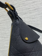 Dior black leather bag corner with curved flap and gold-tone ring handle