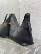 Dior quilted shoulder bag with detachable charm, gold-tone clasp, and shoulder strap