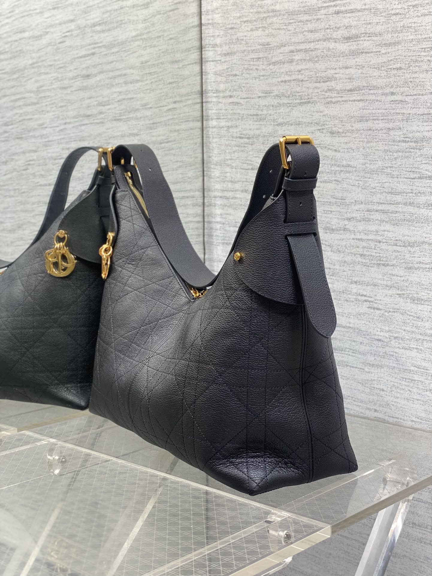 Dior quilted shoulder bag with detachable charm, gold-tone clasp, and shoulder strap