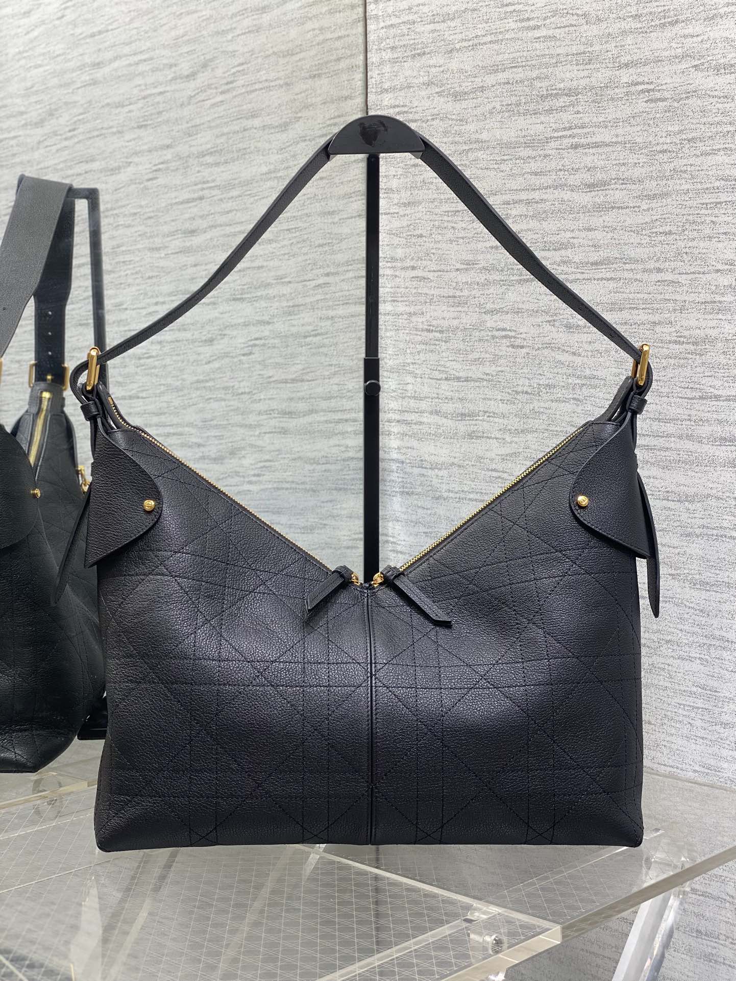 Dior quilted shoulder bag with gold-tone accents and dual short straps