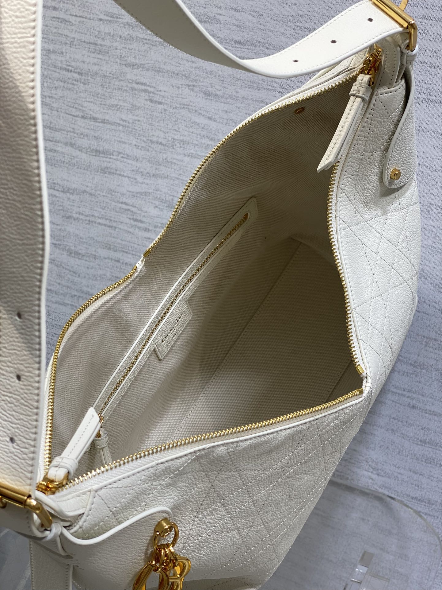 Dior bag open top with white leather, gold zipper and interior logo patch