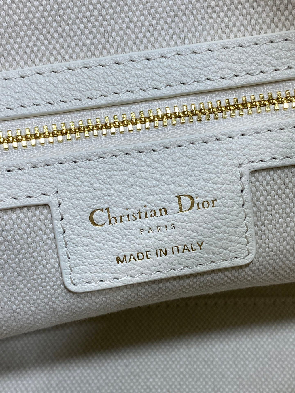 Dior bag interior label reading Christian Dior Paris, Made in Italy