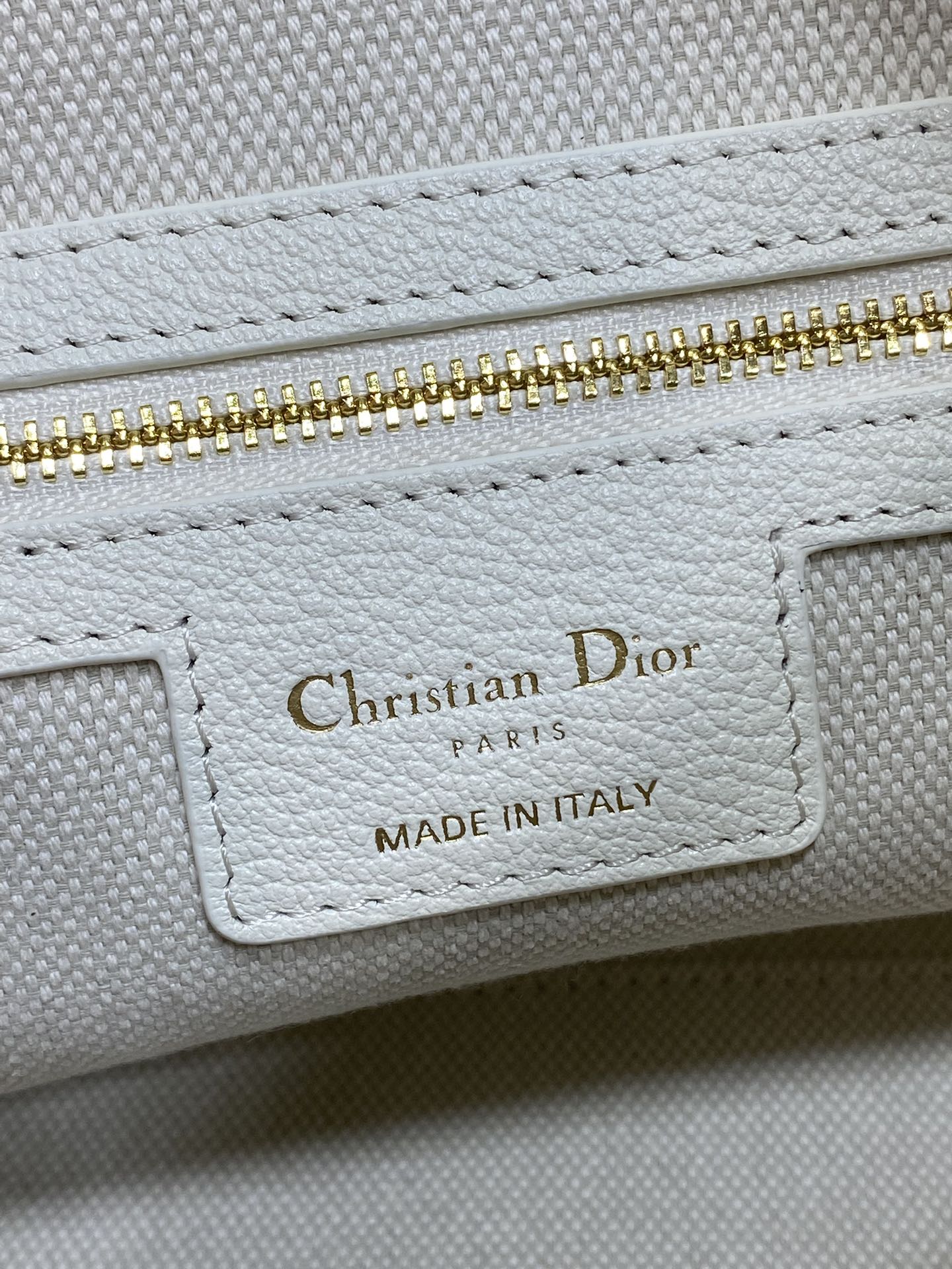 Dior bag interior label reading Christian Dior Paris, Made in Italy