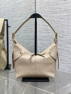 Dior handbag in light beige textured leather with gold hardware and shoulder straps