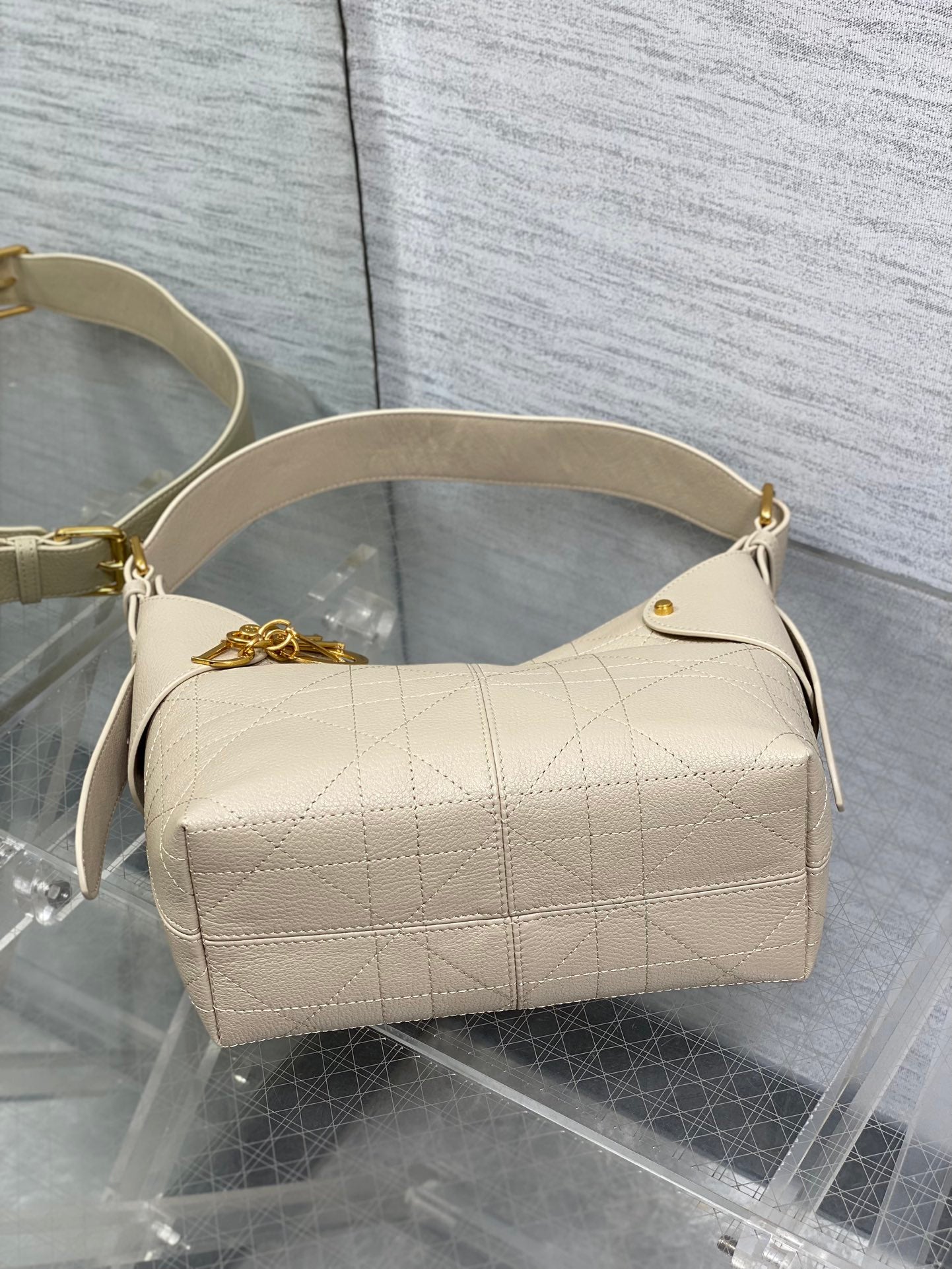 Dior shoulder bag in light beige textured leather with gold hardware and top handle
