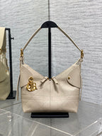 Dior handbag in light beige textured leather with gold hardware and shoulder straps
