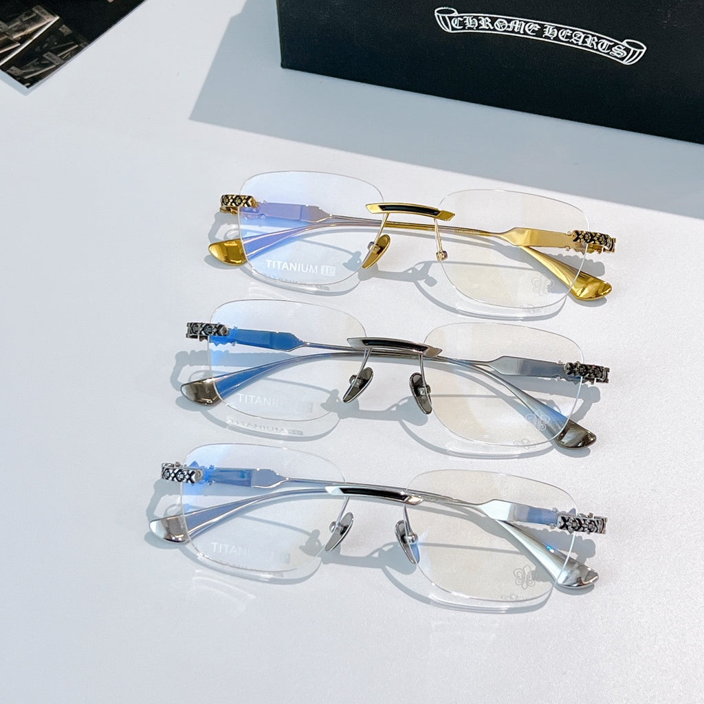 Eyeglass frames with tinted blue lenses in gold and silver, featuring patterned temples