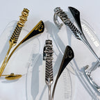 Eyeglass hinges and temple details in gold, silver, and black with patterned finish