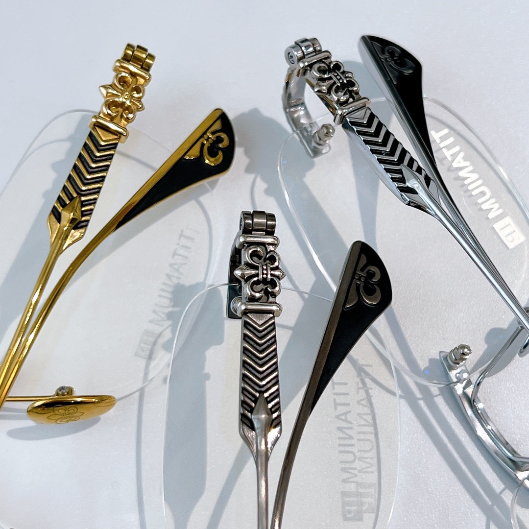 Eyeglass hinges and temple details in gold, silver, and black with patterned finish